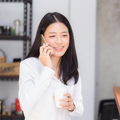 A lady chatting on phone with a smile