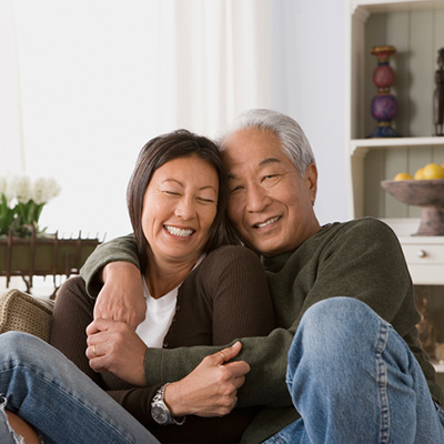 an old couple hugging each other and smiling
