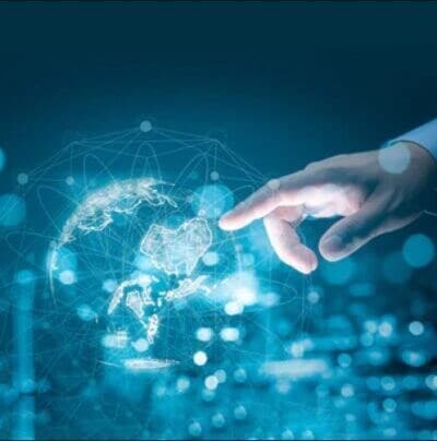 finger pointing to digital image of a global